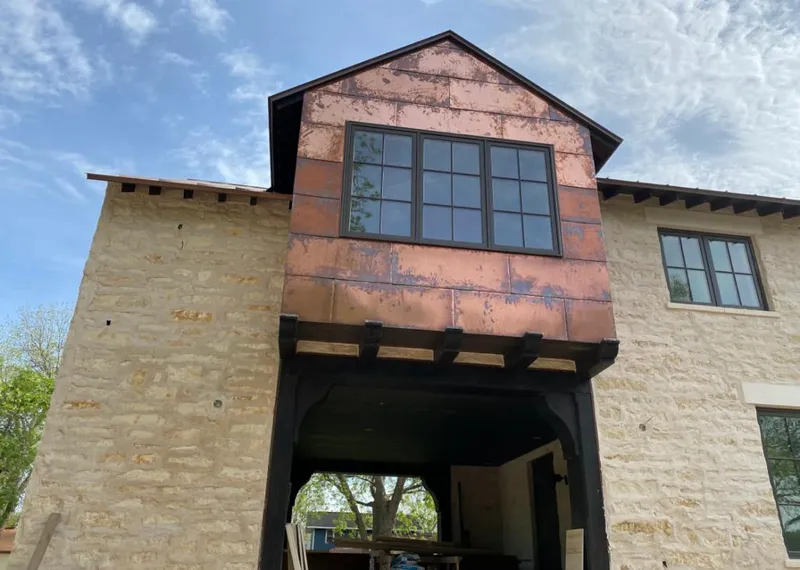 Copper metal panel facade on a stone building for Roof Repair in Brookville