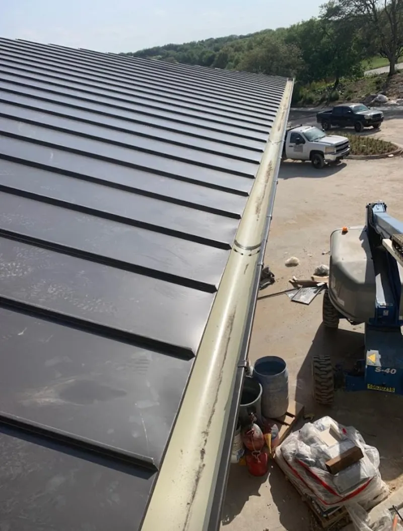 Standing seam panel and gutter detail on a metal roofing jobsite in Brookville